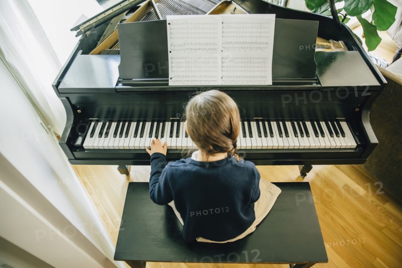 Mixed race girl playing piano