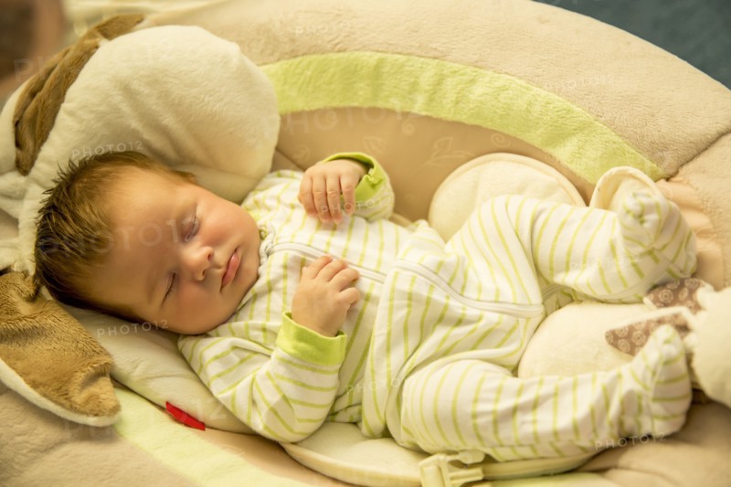 Close up of Caucasian baby boy sleeping on cushion