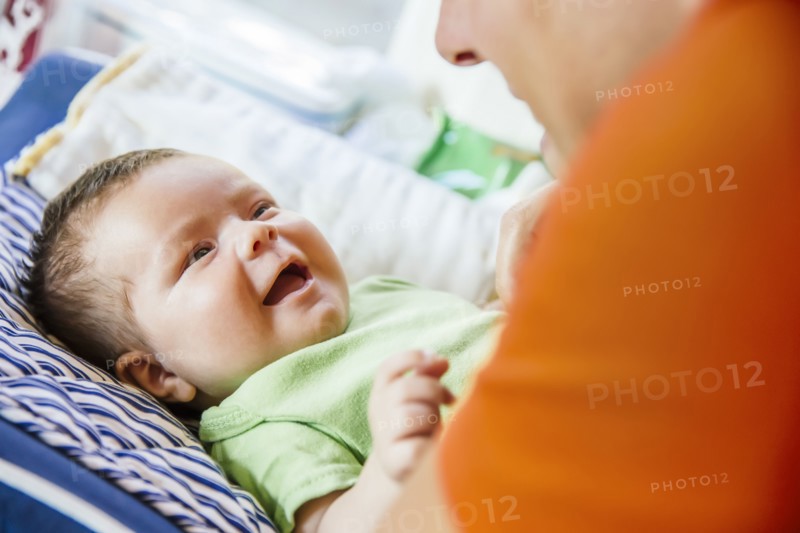 Caucasian father playing with baby boy