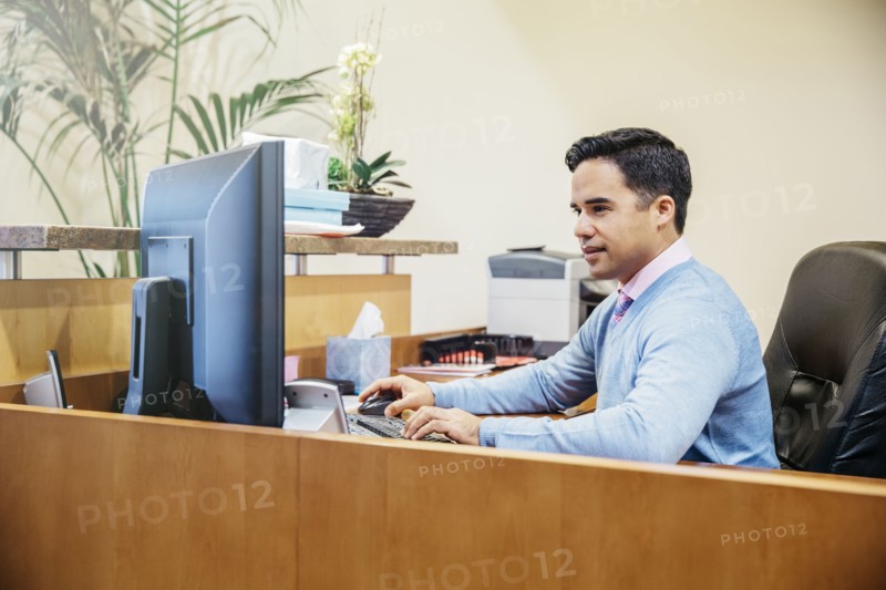 Mixed race secretary working in office lobby