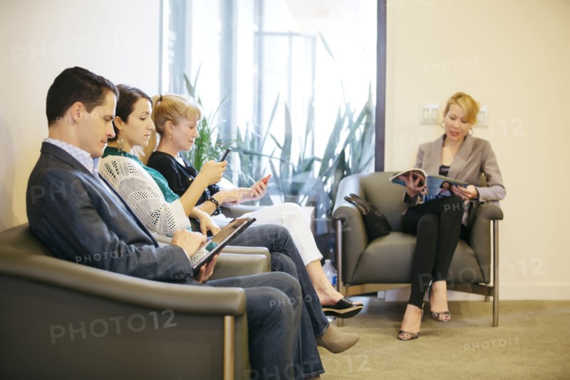 Business people waiting in office lobby