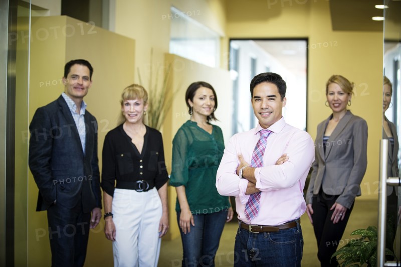 Business people smiling in office hallway