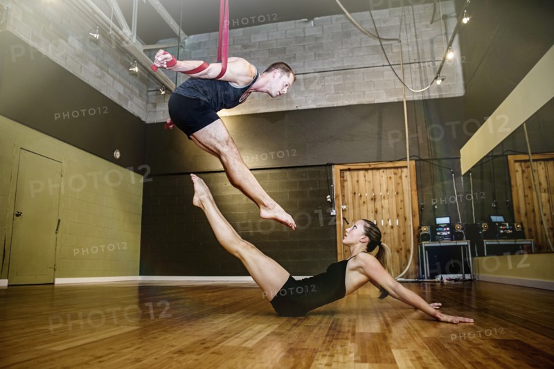 Caucasian acrobats training on ropes in studio