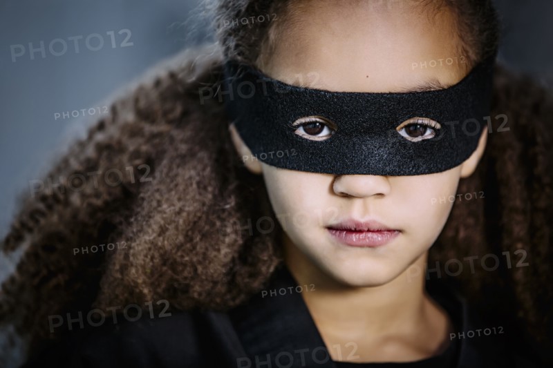 Close up of mixed race girl wearing mask