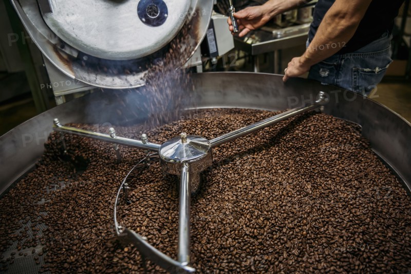 Caucasian roaster working on coffee in machinery
