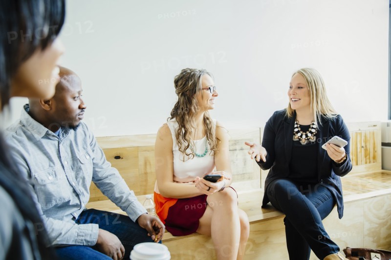 Business people talking in office lobby