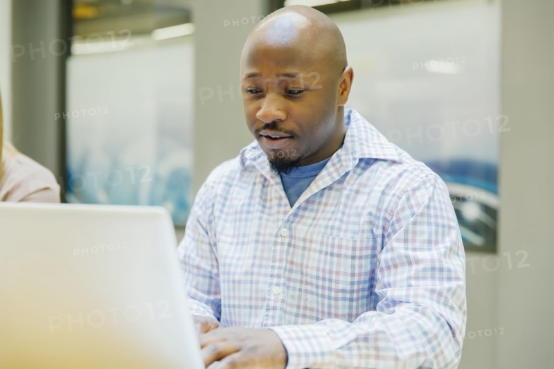 Businessman working on laptop in office