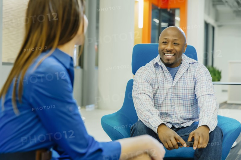 Business people talking in office lobby