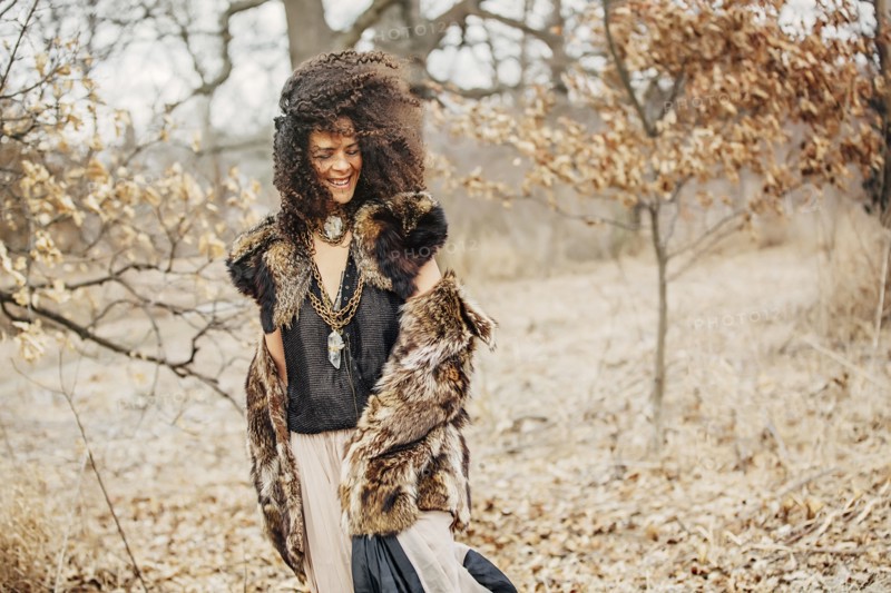Mixed race woman wearing stylish clothes in field