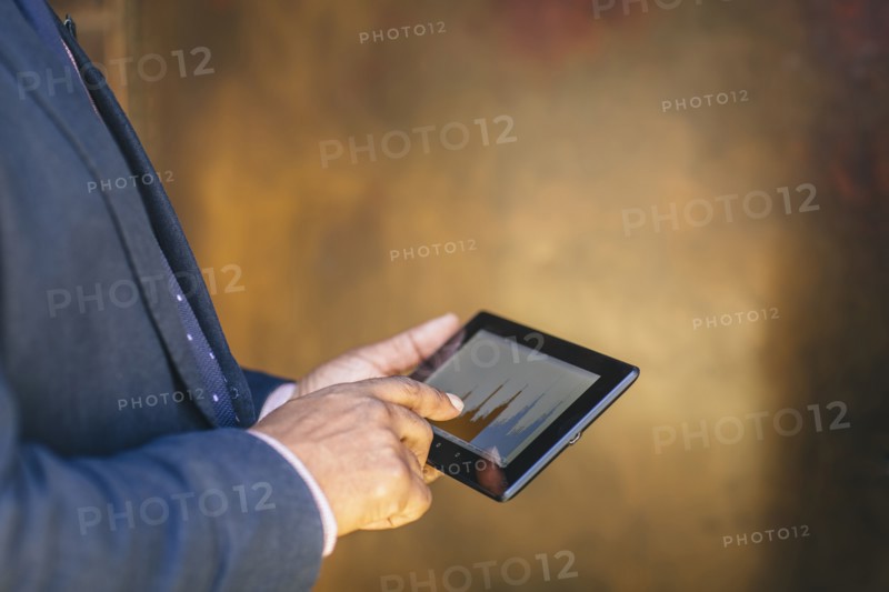 Mixed race businessman using digital tablet