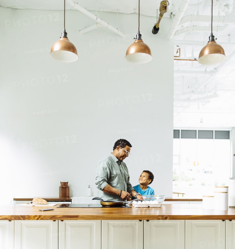 Father and son cooking in kitchen