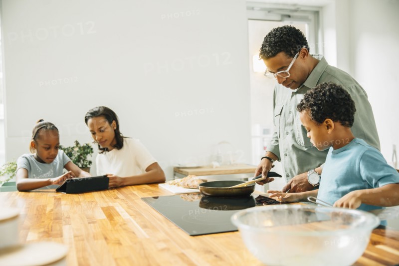 Family cooking in kitchen