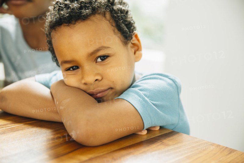 Close up of boy leaning on table