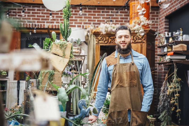 Caucasian employee smiling in plant nursery