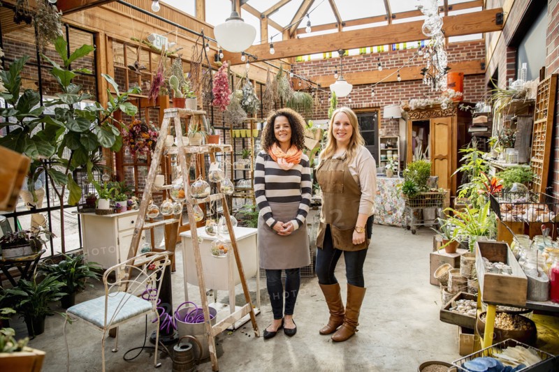 Employee and customer smiling in plant nursery