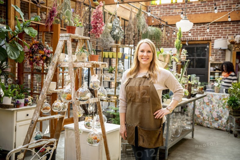 Employee smiling in plant nursery