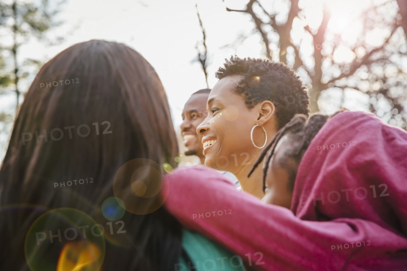 Low angle view of Black family smiling outdoors