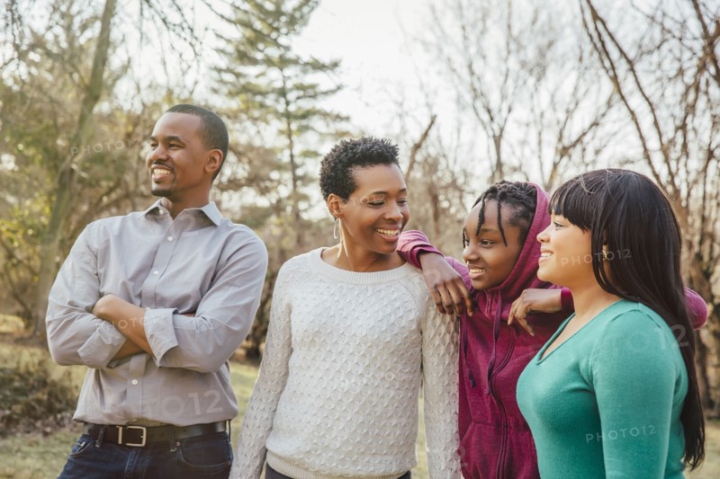 Black family smiling outdoors