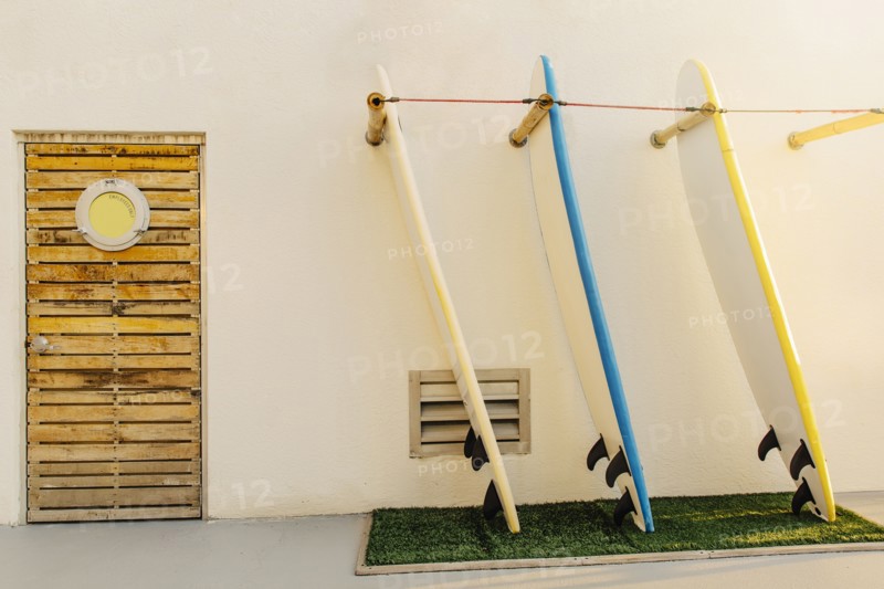 Surfboards in rack on building exterior