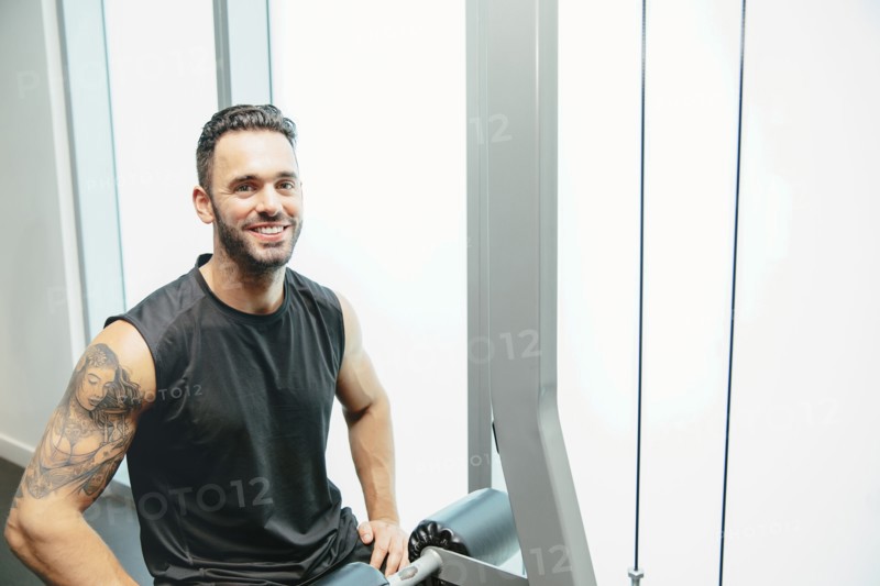Man using exercise machine in gymnasium