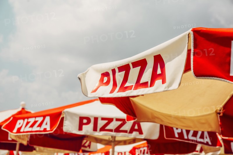 Low angle view of pizza on umbrellas outdoors