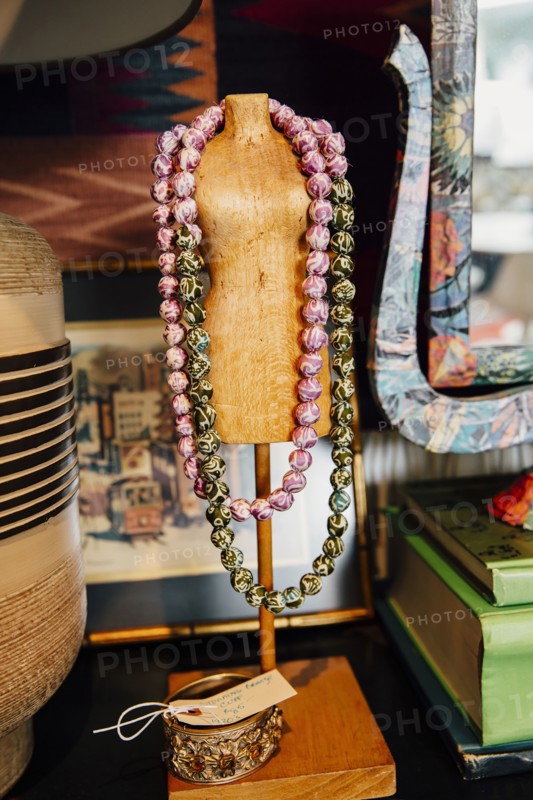 Necklaces draped over mannequin stand