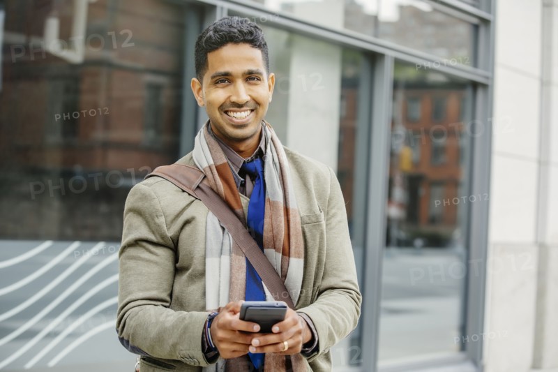 Indian man using cell phone in city