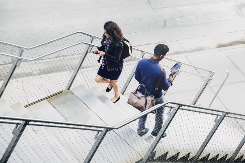 People using cell phones on city steps