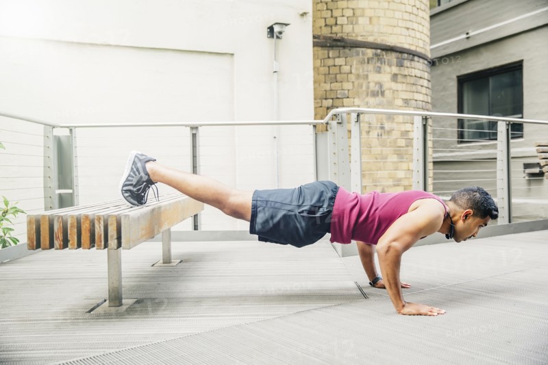Indian man doing push-ups on bench