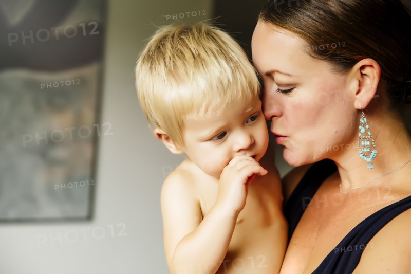 Close up of mother holding son in living room