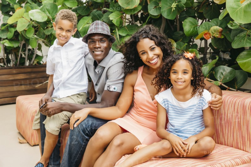 Family smiling on sofa in garden