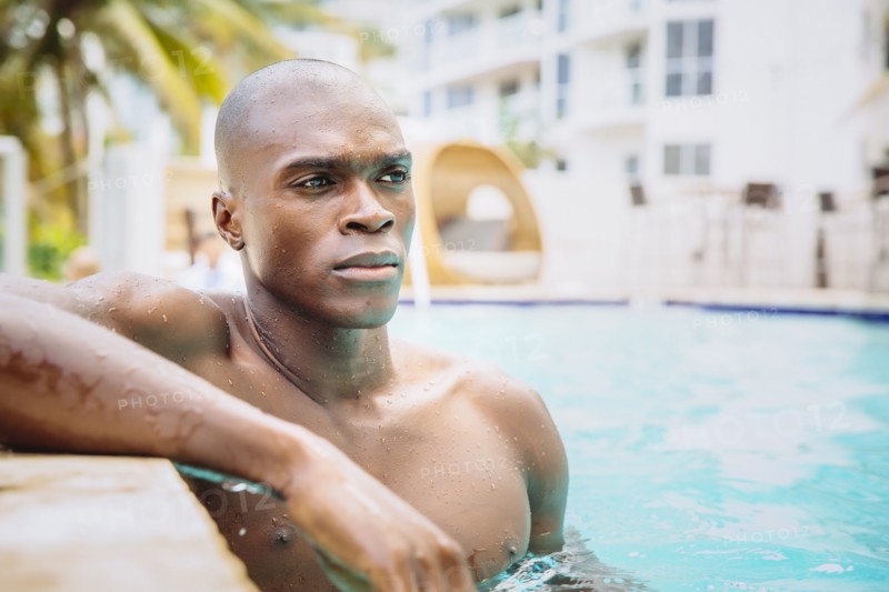 Black man standing in swimming pool