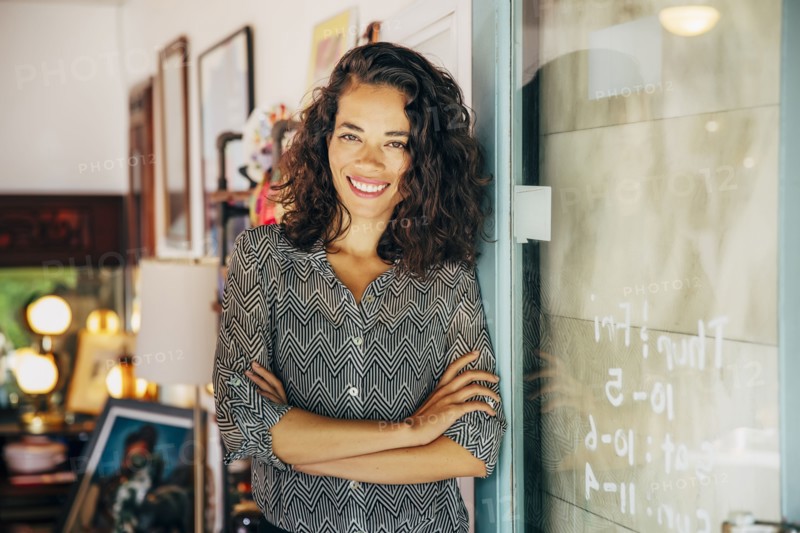 Mixed race entrepreneur standing in store