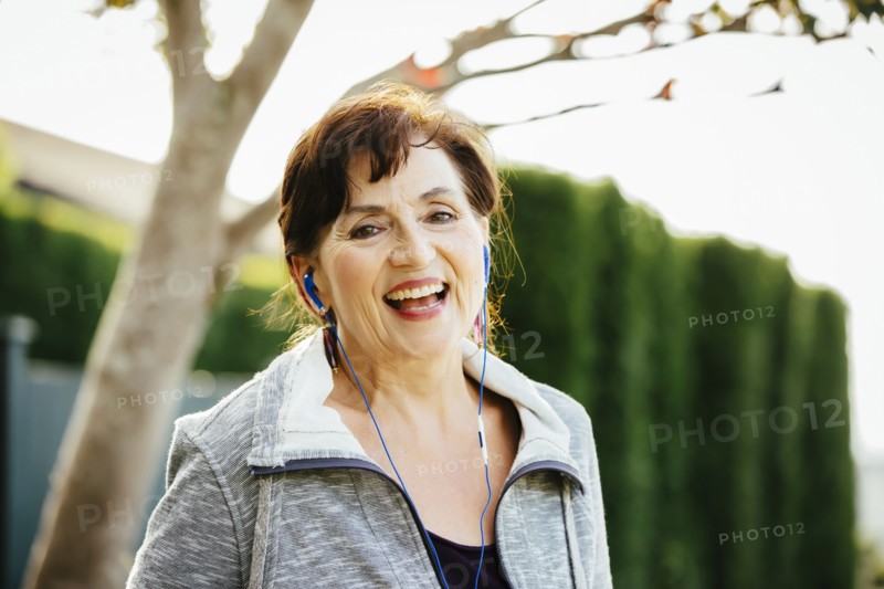 Caucasian woman listening to earbuds outdoors