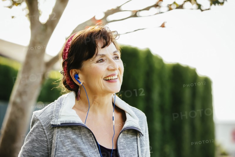 Caucasian woman listening to earbuds outdoors