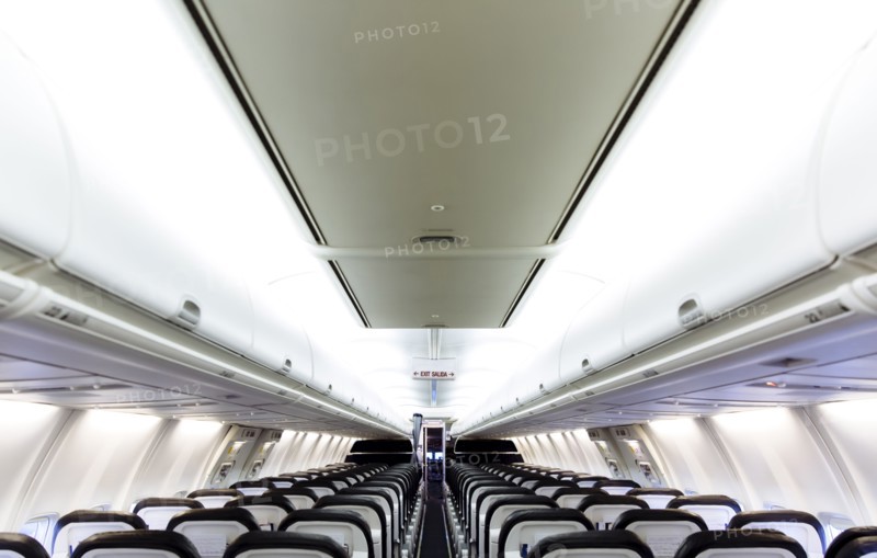 Empty chairs and compartments in airplane