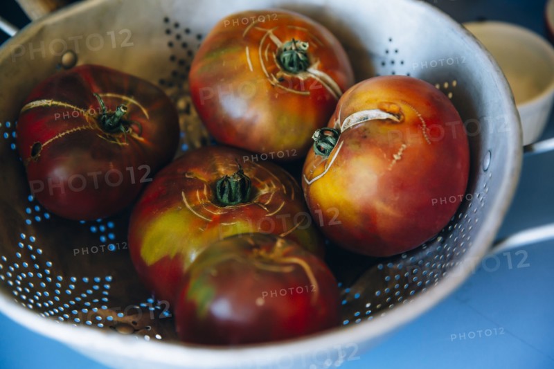 Close up of fresh tomatoes in colander