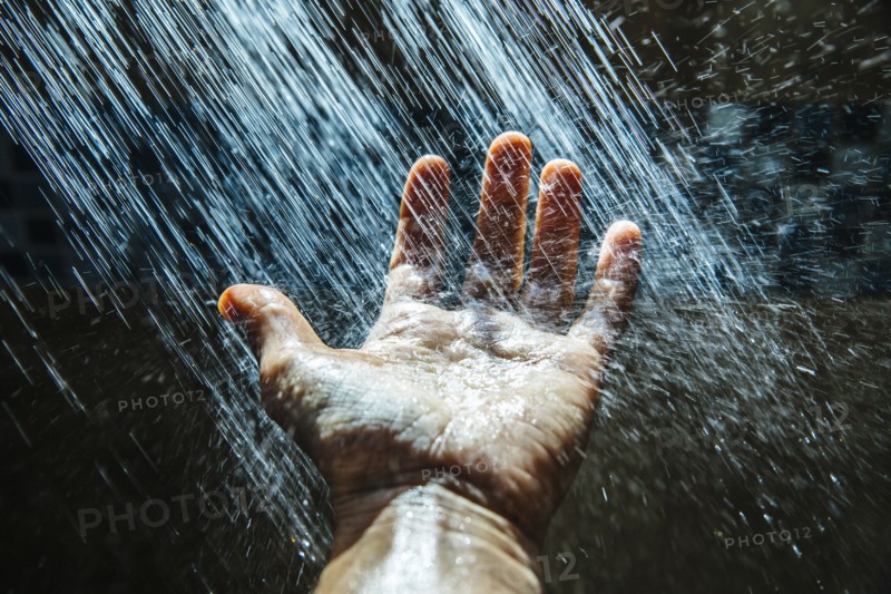 Caucasian man rinsing hand under water