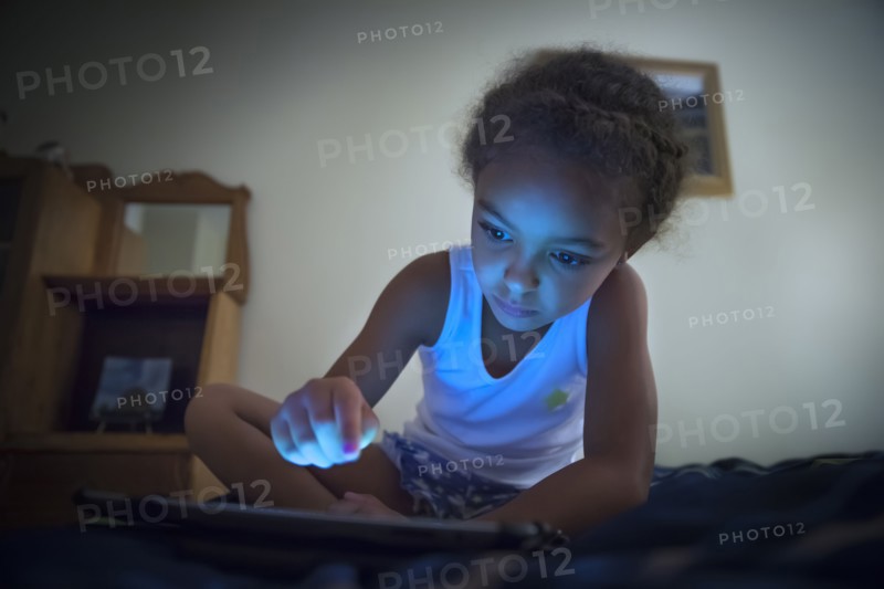 Mixed race girl using digital tablet