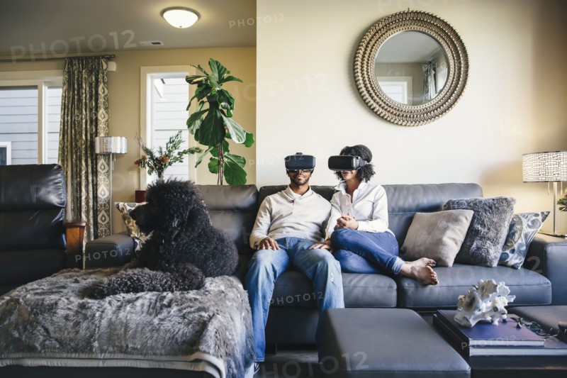 Couple using virtual reality goggles