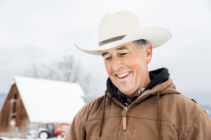 Caucasian farmer smiling in snow