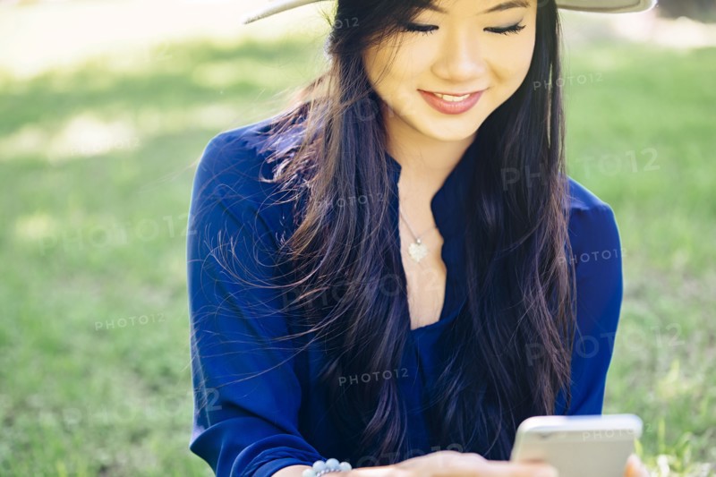 Chinese woman using cell phone outdoors
