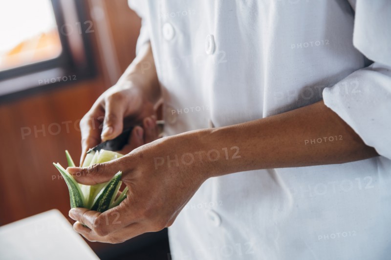 Close up of chef cutting decorative lime