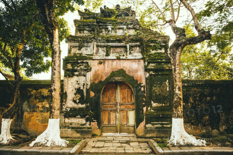 Mossy ornate archway and fence