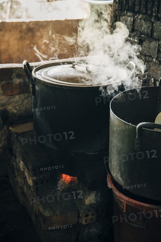 Close up of steamy pot cooking on stove