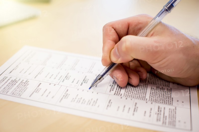 Caucasian businessman writing paperwork