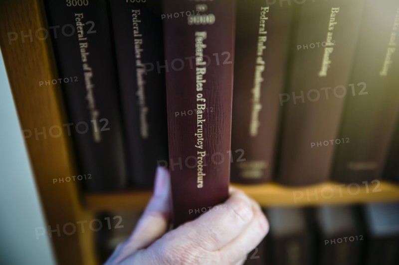 Caucasian woman selecting reference book from shelf