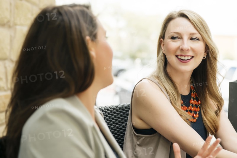 Caucasian women talking at table