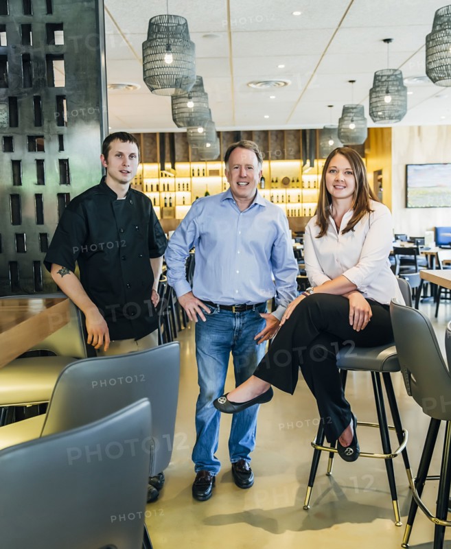 Caucasian men and woman smiling in restaurant