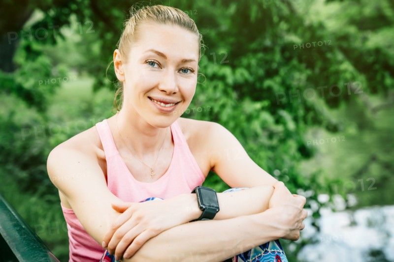 Caucasian woman wearing smart watch sitting outdoors